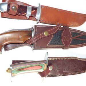 Three Bowie Knives  - Three Bowie hunting knives with genuine leather sheaths.